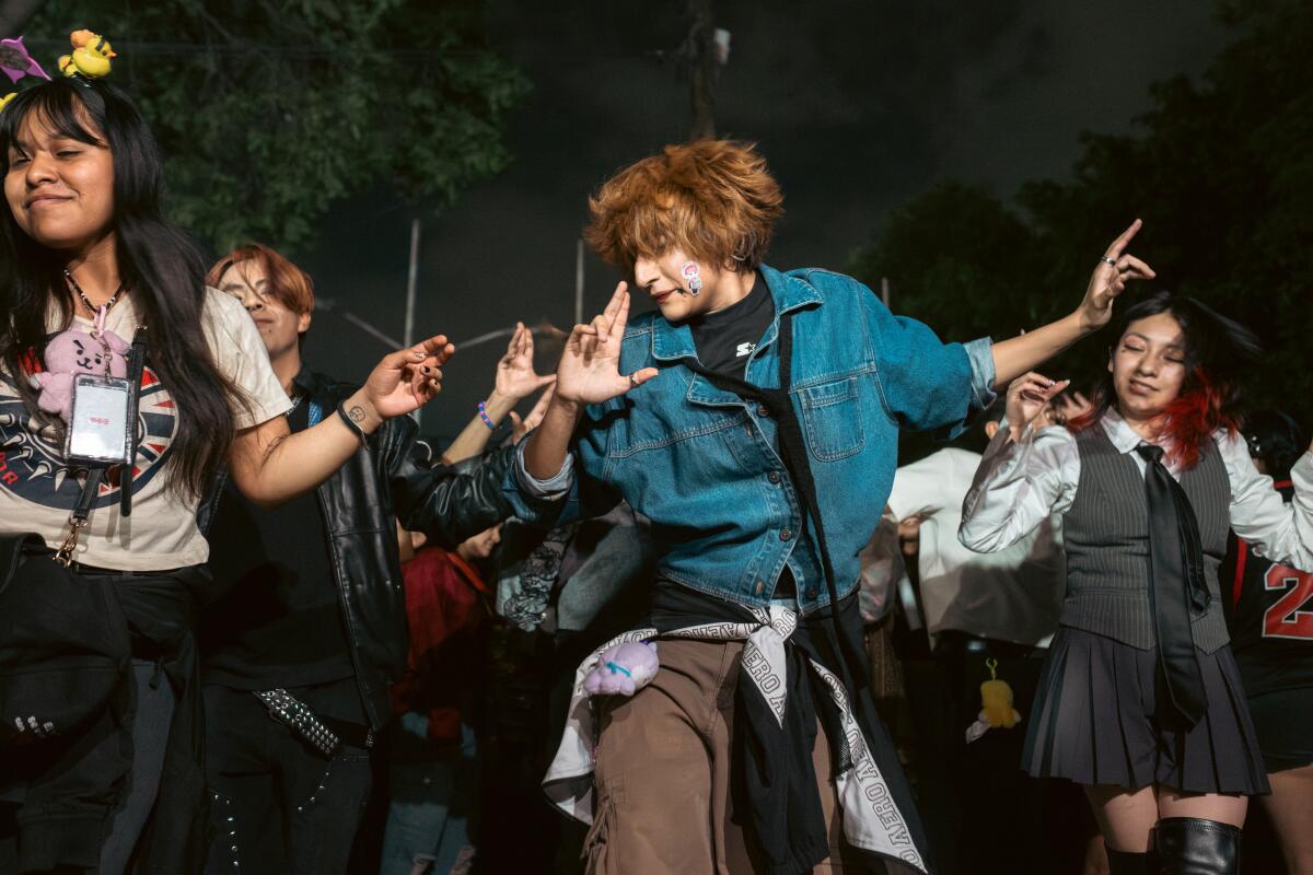 BTS fans gather to dance outside Estadio GNP Seguros in Mexico City, Thursday, May 7, 2026.