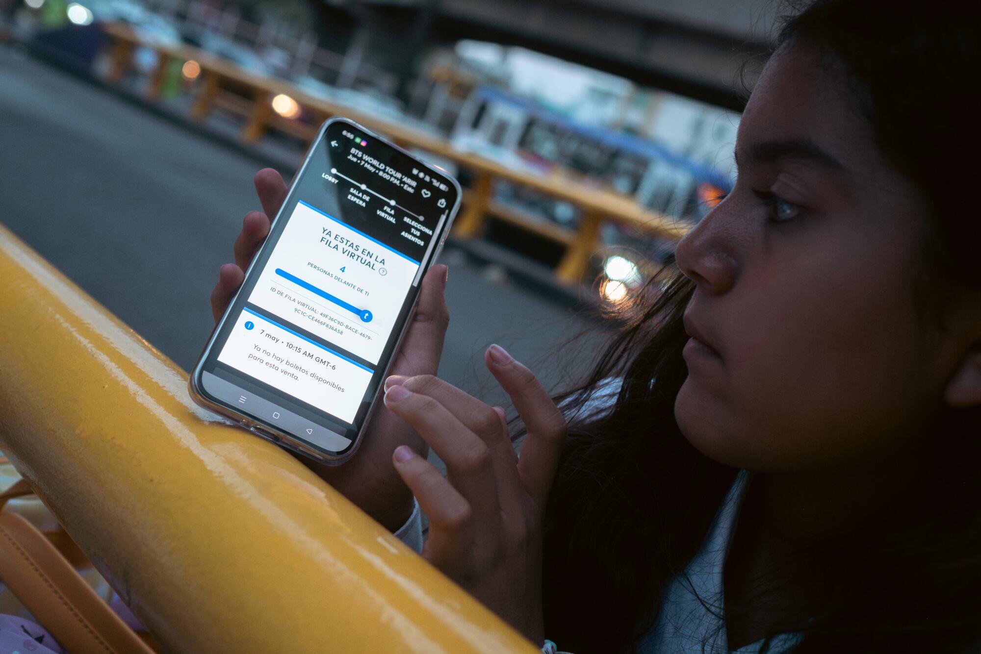 Zoe Castro, 12, who has been a BTS fan since she was 6, try to buy tickets online outside.