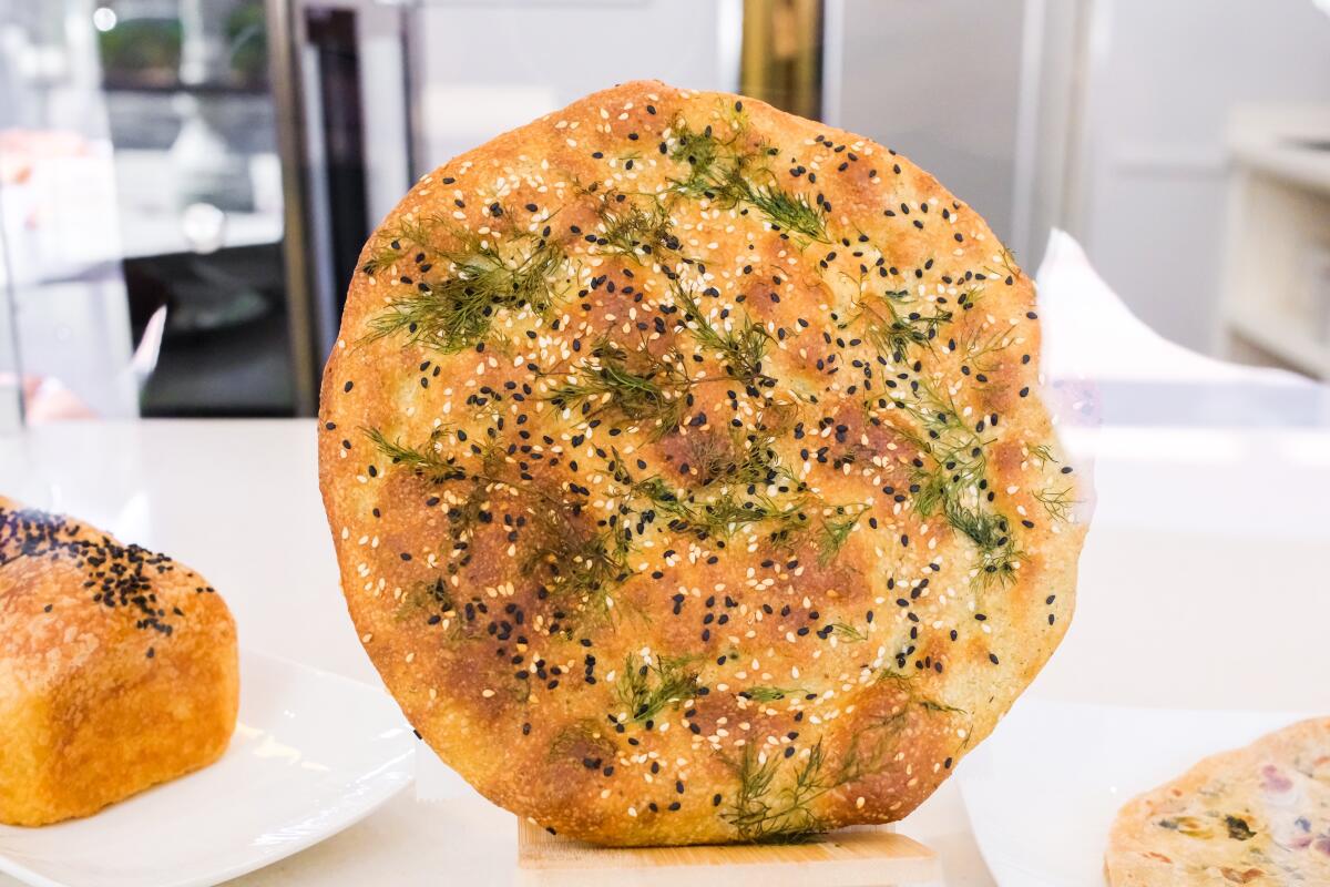Latir, a flatbread crusted with sesame seeds, cumin and fresh dill, at the new Kouzeh Bakery in Mid-Wilshire.