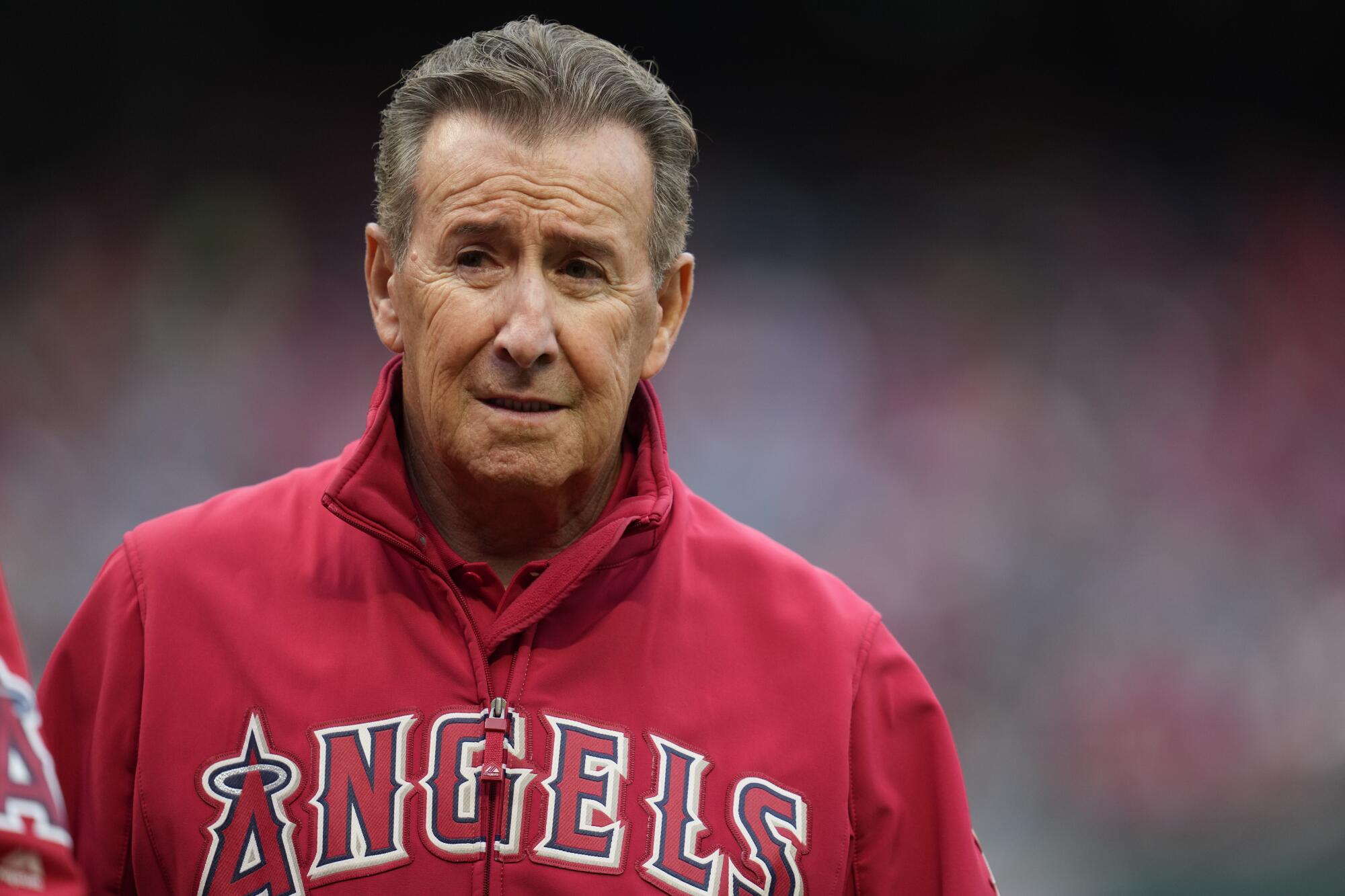 Arte Moreno, owner of the Los Angeles Angels, stands on the field before a baseball game