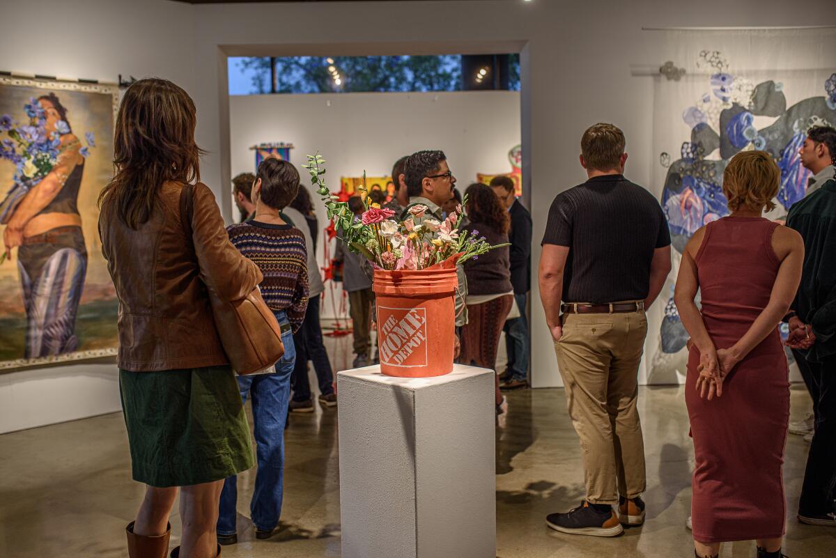 Art lovers mingle around artwork like "Azusa Ave" (2024) by Alyssa Dolleschal.