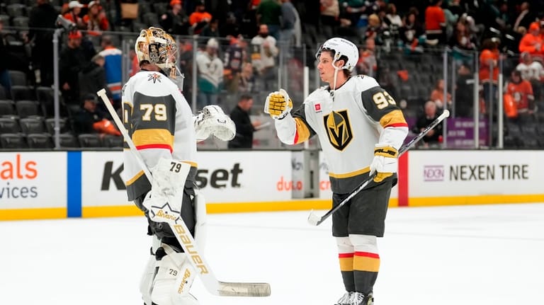 Vegas Golden Knights goaltender Carter Hart, left, and right wing...