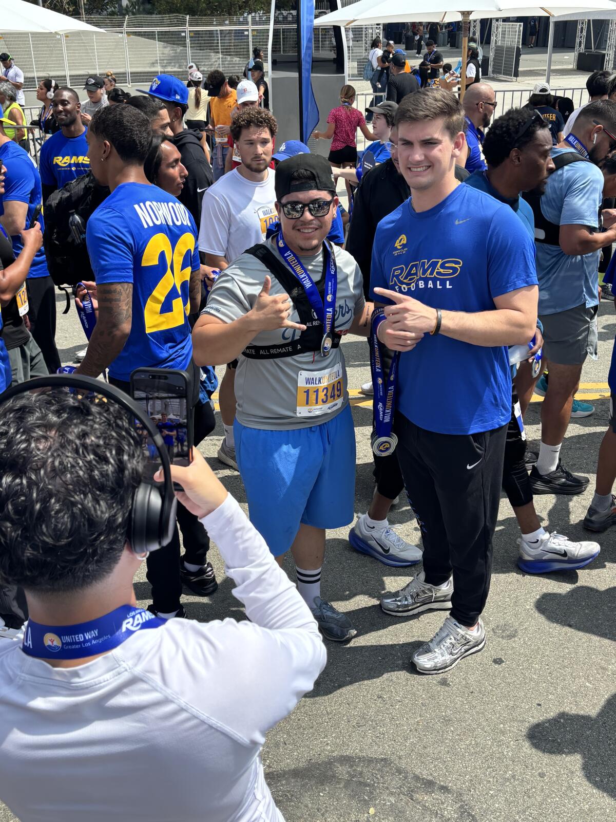 Rams quarterback Ty Simpson, right, poses with a fan during a WalkUnitedLA fundraising event on Saturday.