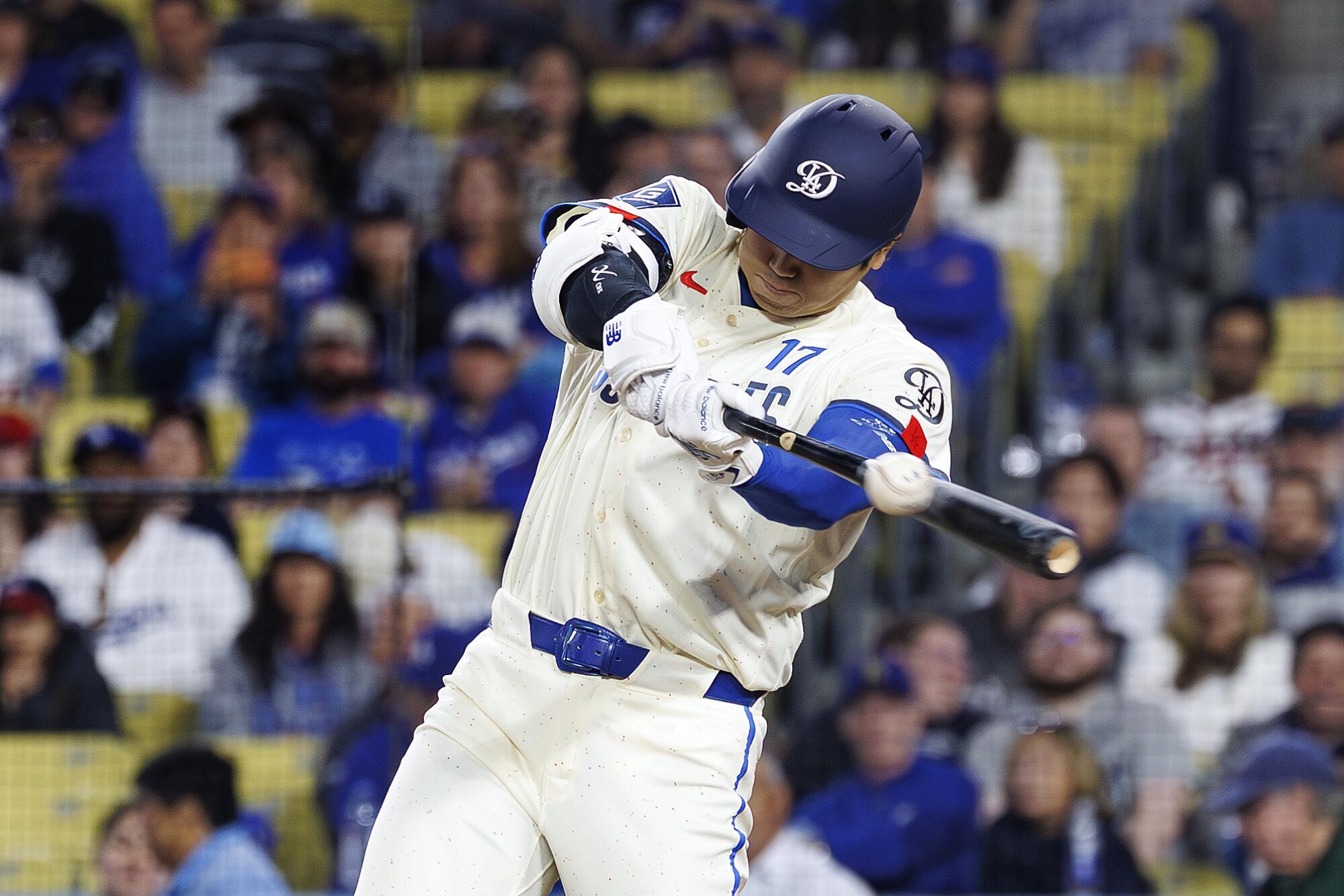 Dodgers star Shohei Ohtani singles down the left-field line during the eighth inning against the Braves on Saturday.