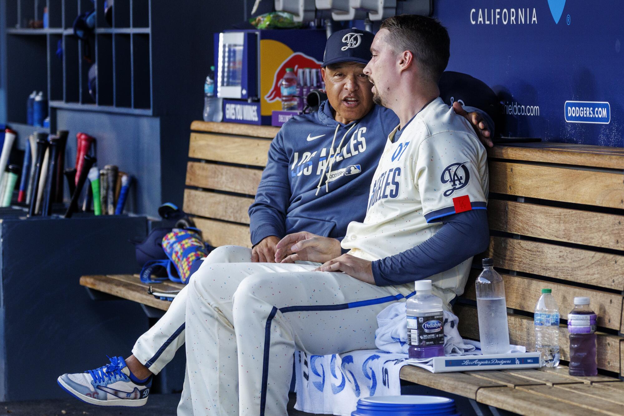Dodgers manager Dave Roberts talks to pitcher Blake Snell during a 7-2 loss to the Atlanta Braves on Saturday.