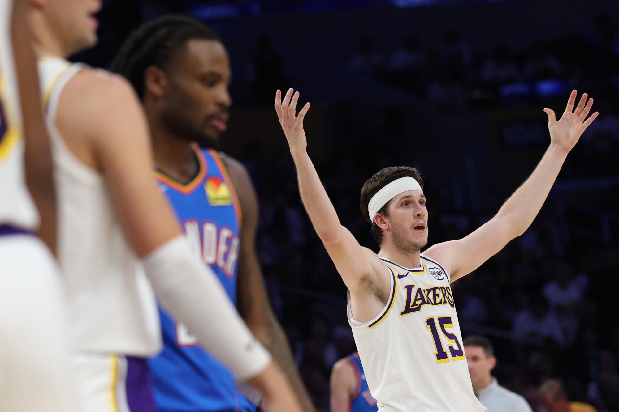 Lakers guard Austin Reaves, right, throws his hand into the air as he complains about a non-call during Game 3.