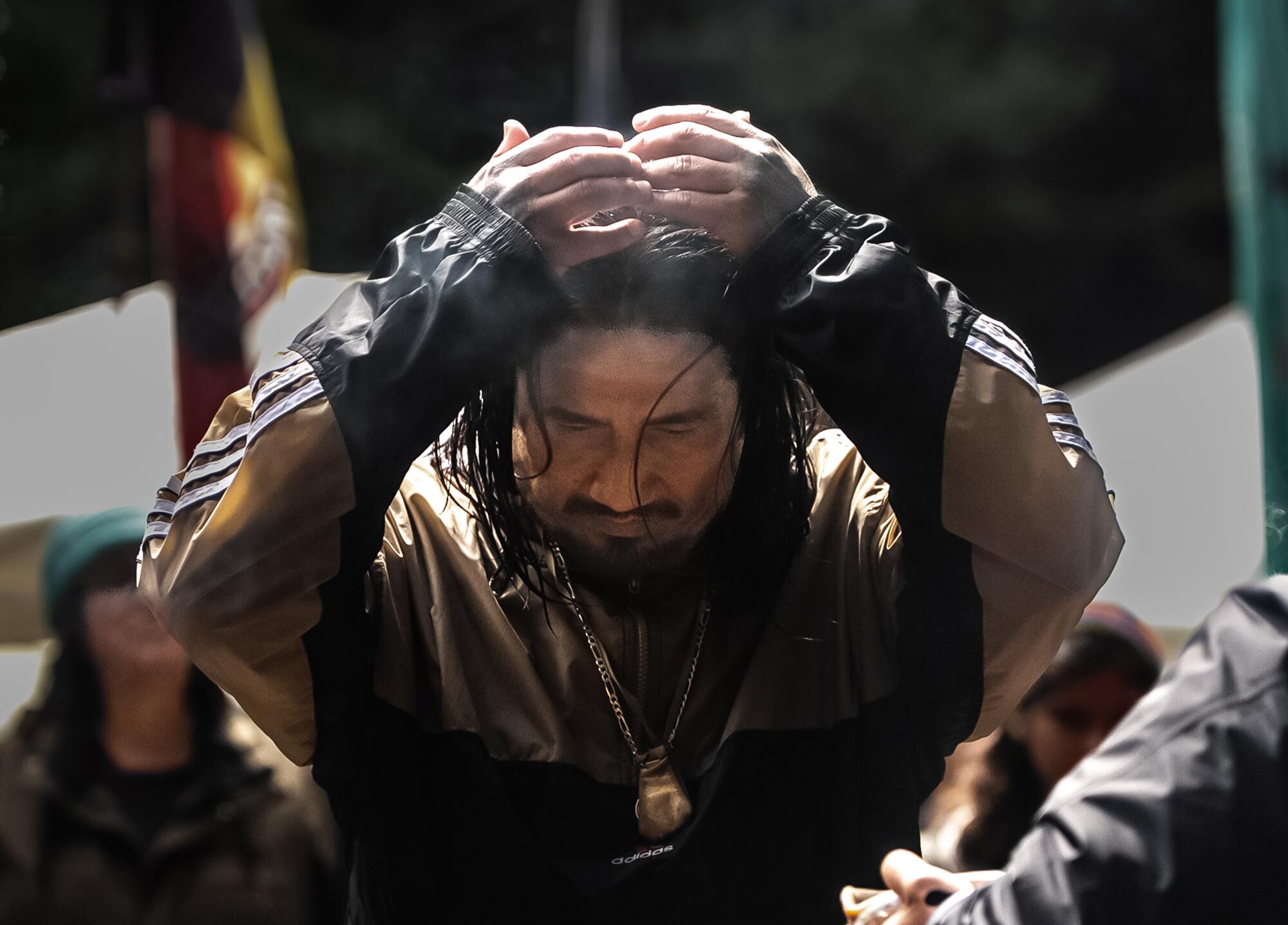 Isidro Chavez receives burning sage after a run in Jackson Demonstration State Forest.