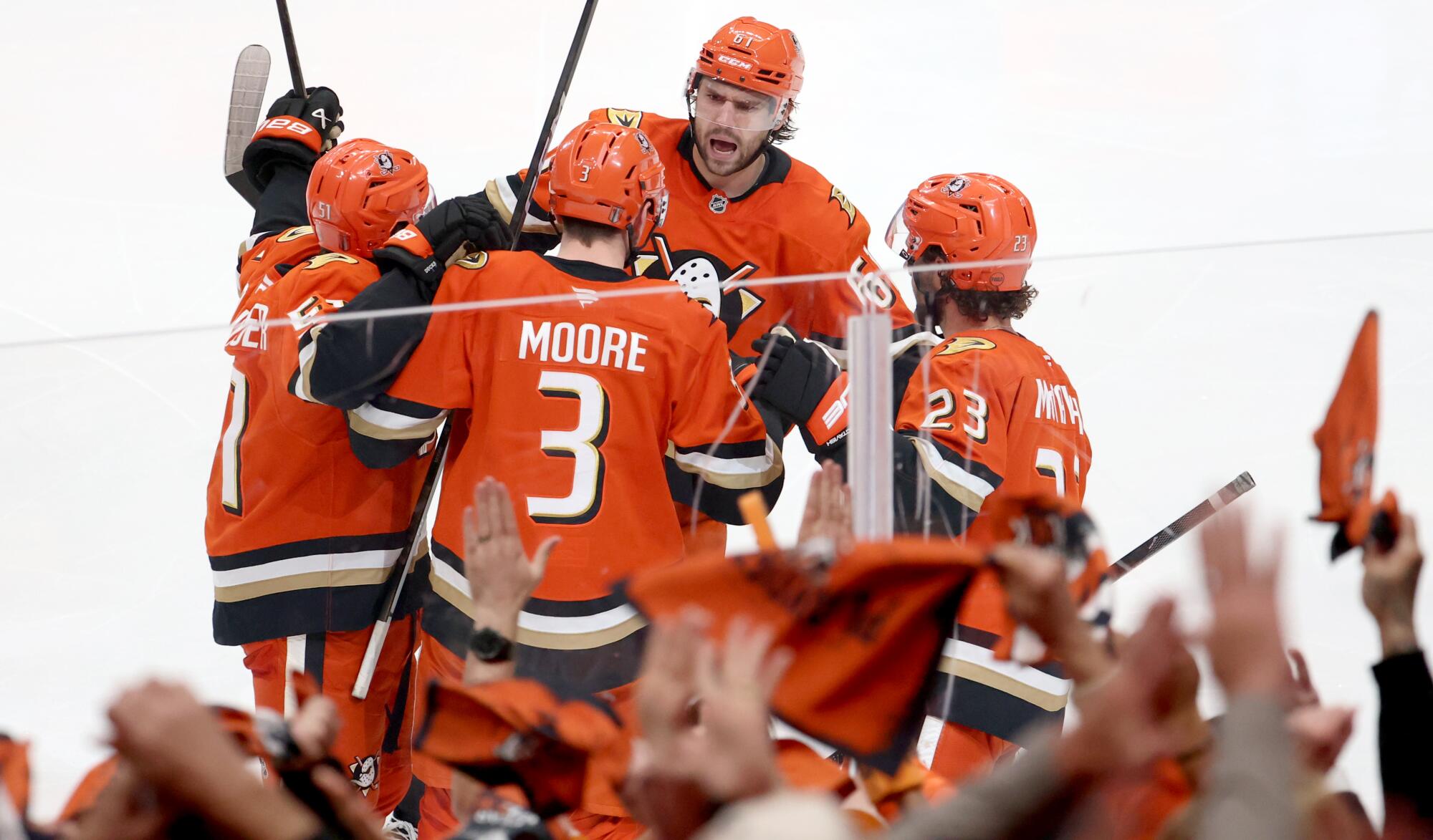Ducks defenseman Ian Moore celebrates with teammates after scoring in the third period.