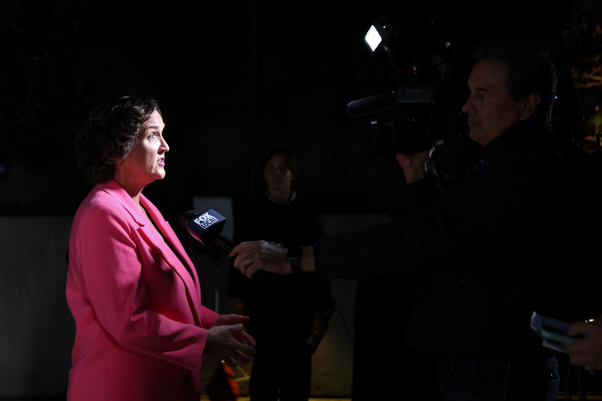 Katie Porter is interviewed by a television reporter