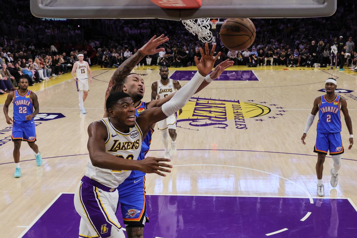 Lakers forward Rui Hachimura tries to shoot a layup in front of Oklahoma City Thunder forward Jaylin Williams.