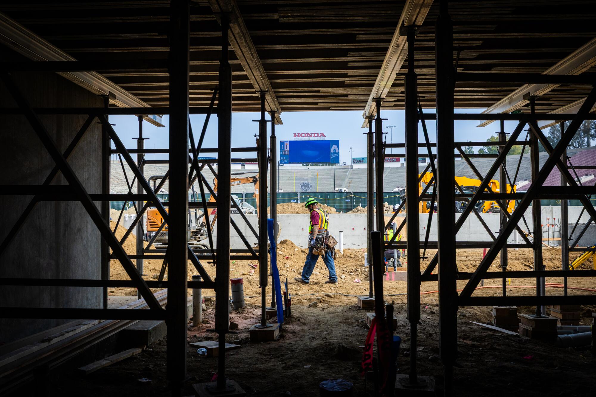 A worker walks through a construction zone at the Rose Bowl on May 2.