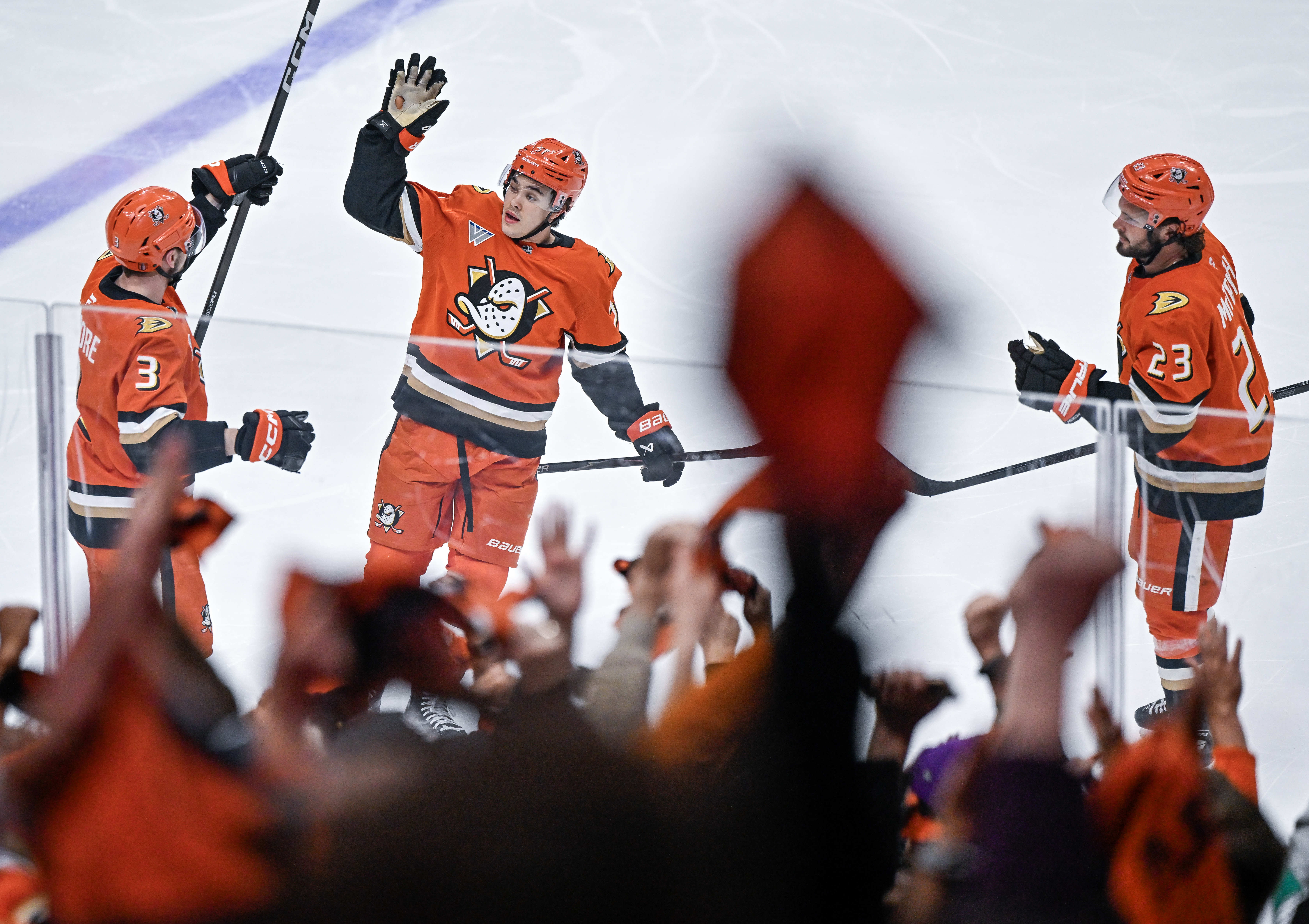 Ducks players celebrate a third period goal by Ian Moore...