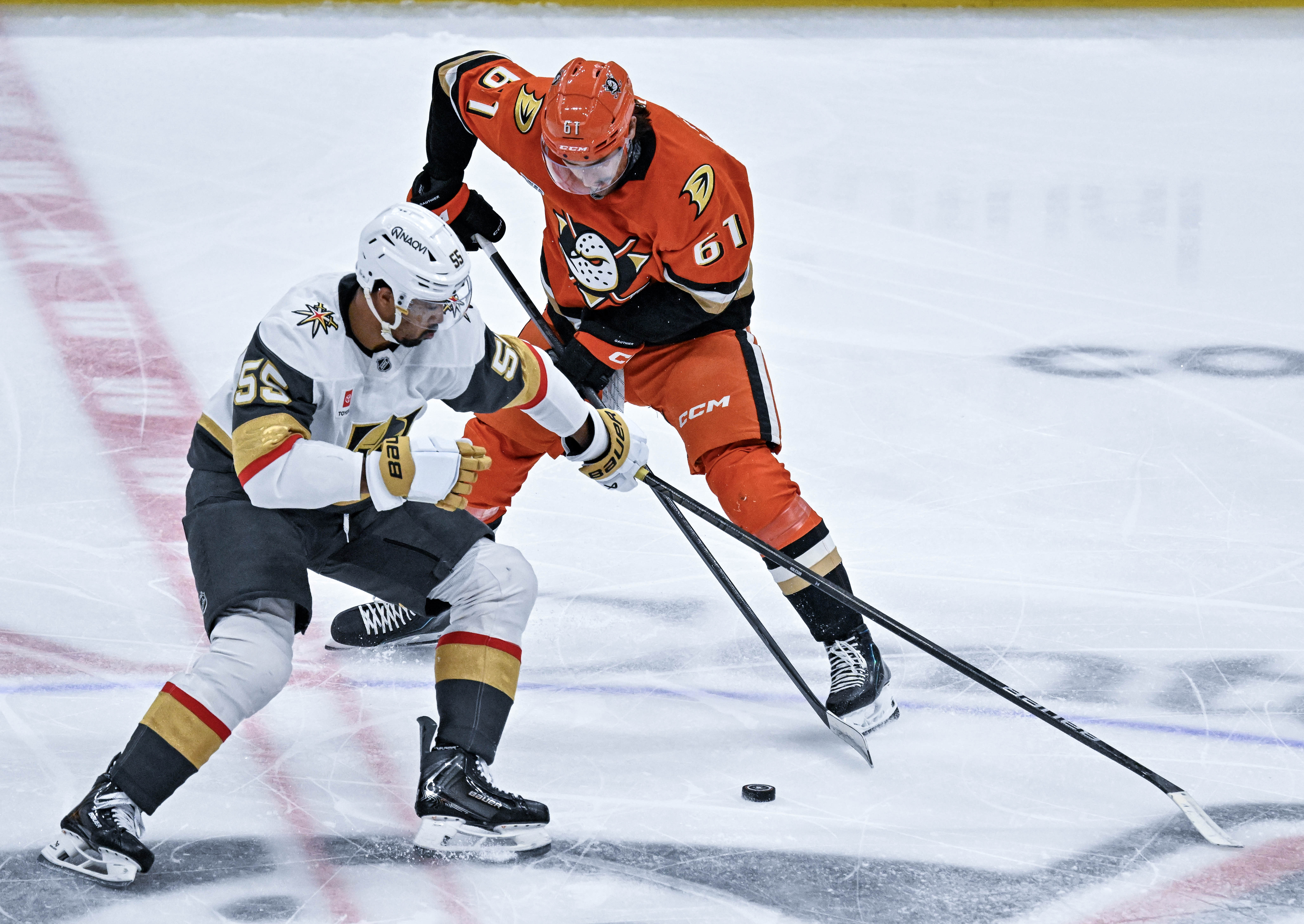 The Golden Knightsâ Keegan Kolesar (55), left, and the Ducksâ...