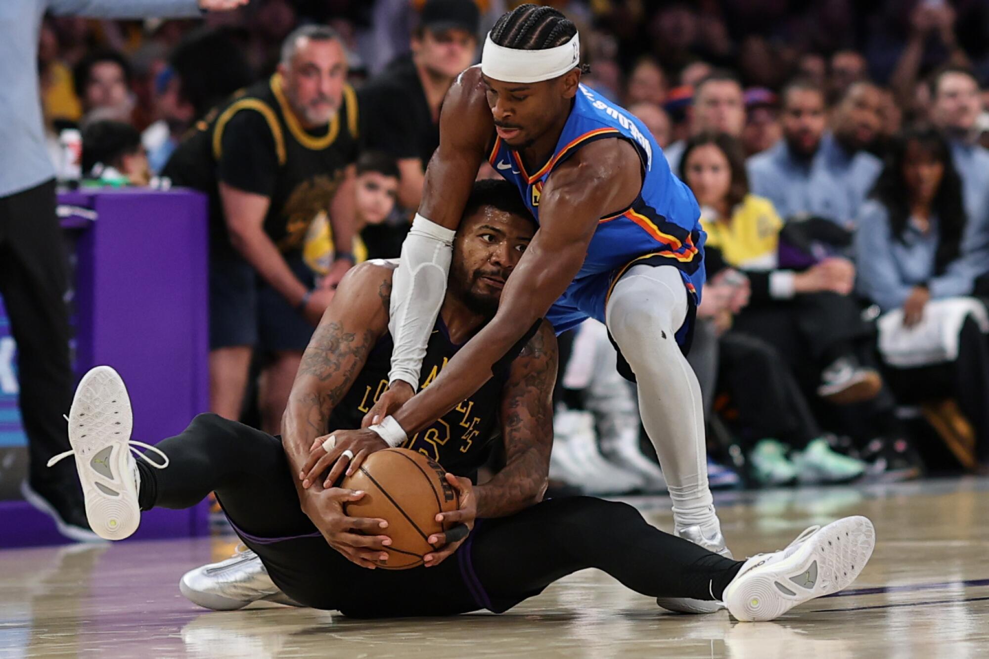 Thunder guard Shai Gilgeous-Alexander, right, ties up Lakers guard Marcus Smart, left, during Game 4.