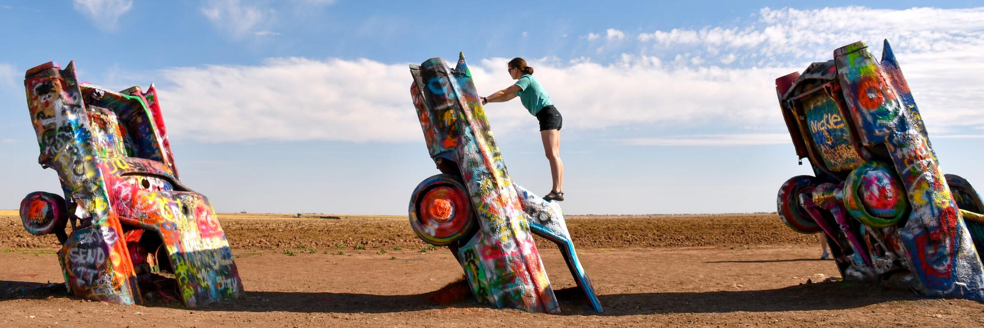 Cadillac Ranch has become one of Amarillo's top attractions. Visitors are invited to add their own spray-painted touches.