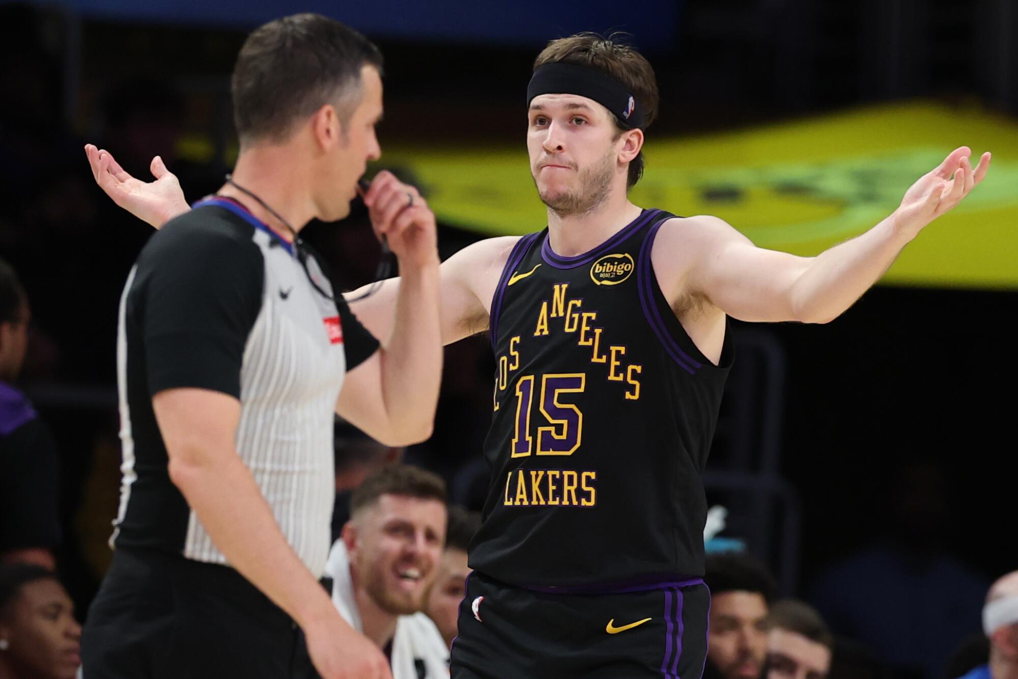 Lakers guard Austin Reaves, right, throws his arms up as he questions an official about a call during Game 4.