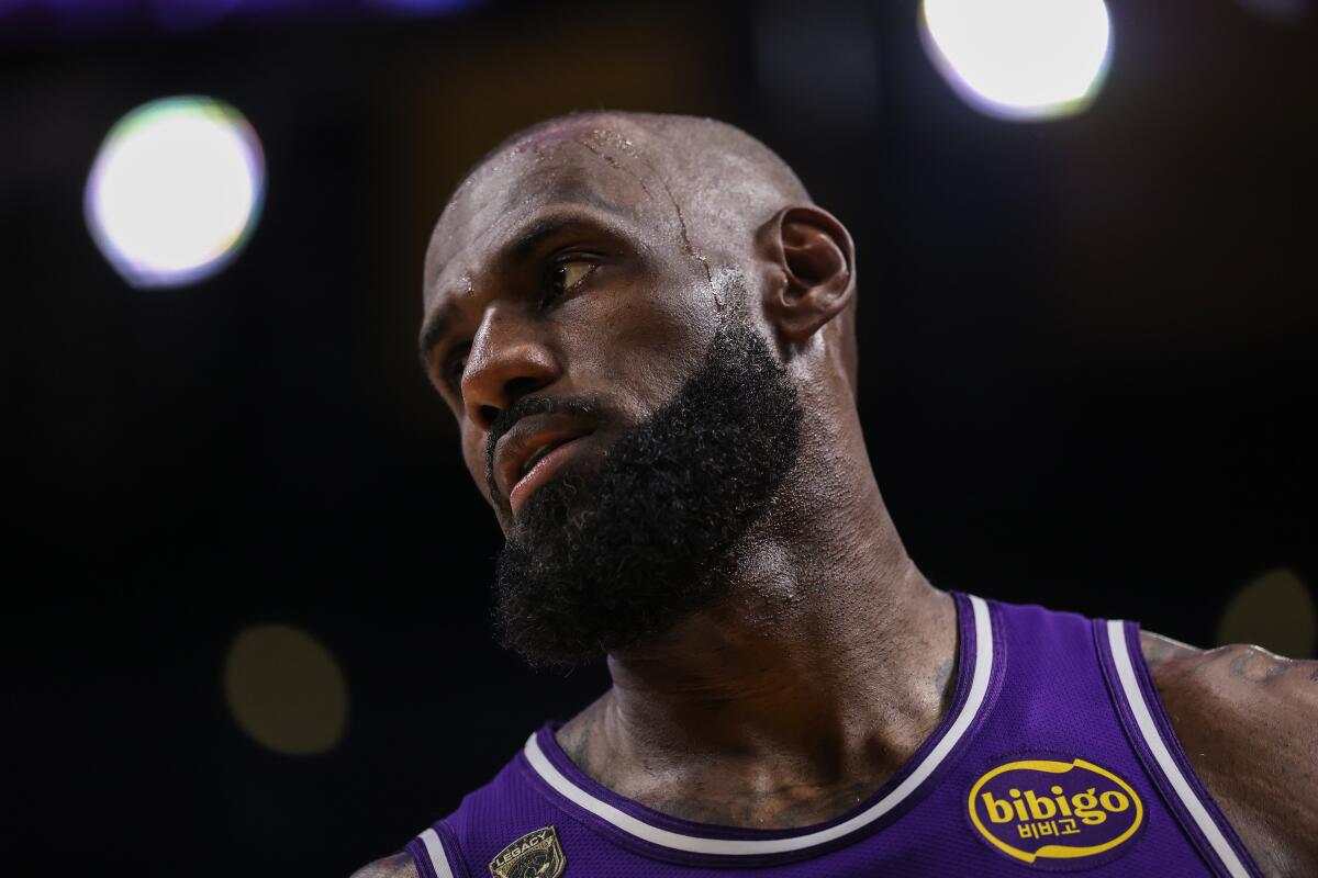 Lakers star LeBron James stands on the court during a game.