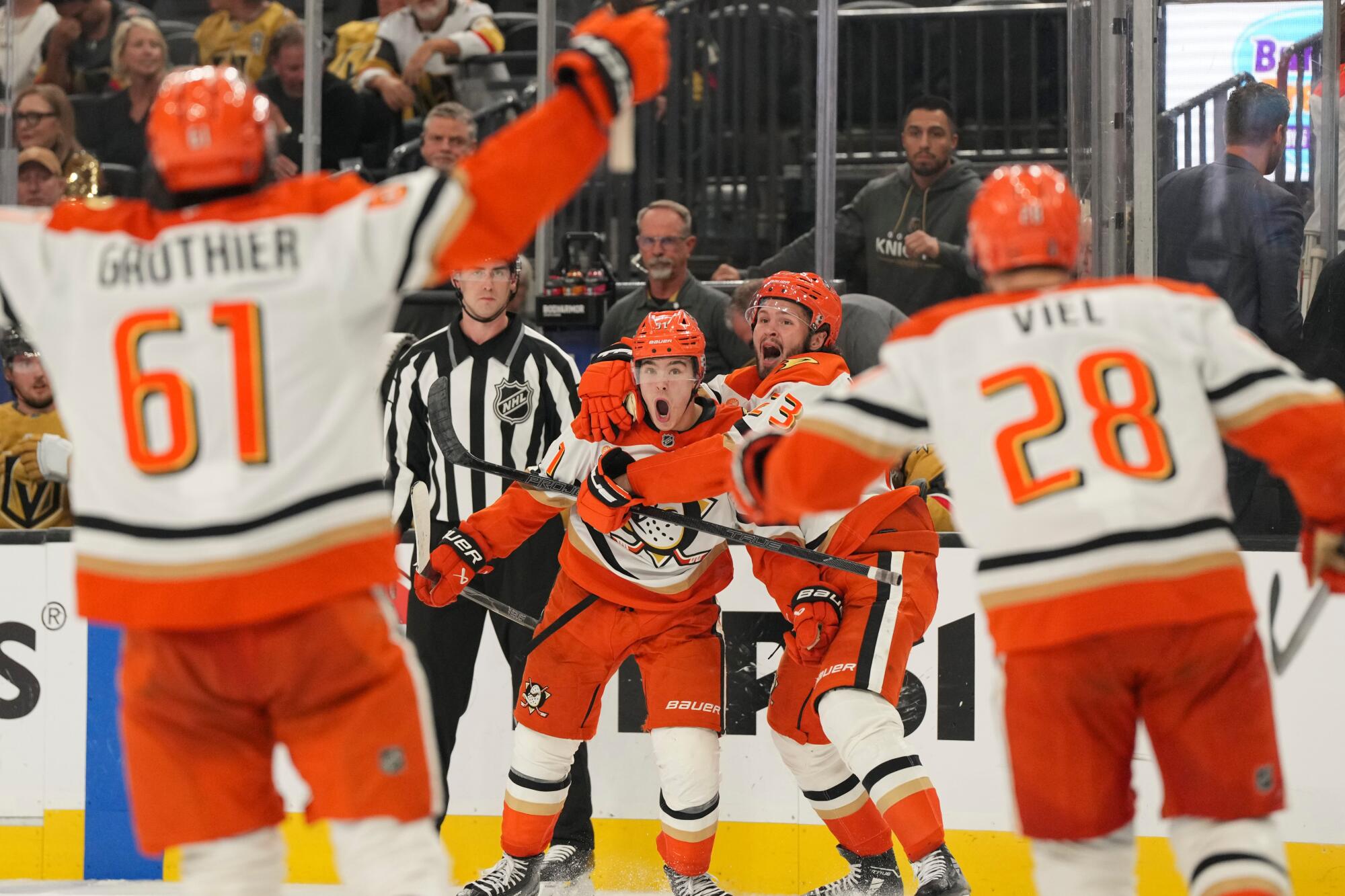 Ducks defenseman Olen Zellweger celebrates with center Mason McTavish after scoring during a playoff game.