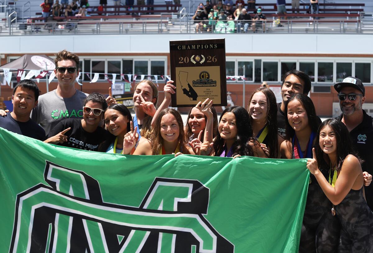Costa Mesa High School's girls' swim team smile and pose with the CIF Championship Division 3 plaque.