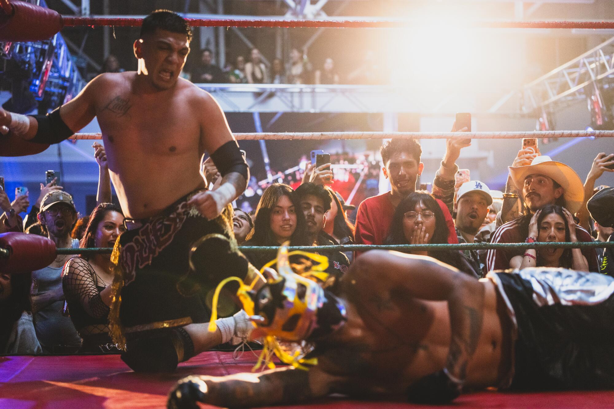 Fans watch as Adrian Quest, left, prepares to attack Skalibur.
