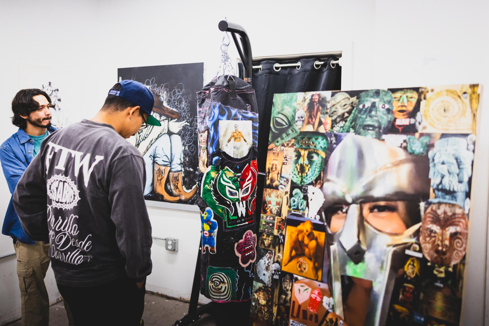 People visit the art gallery at the Lucha Experience 