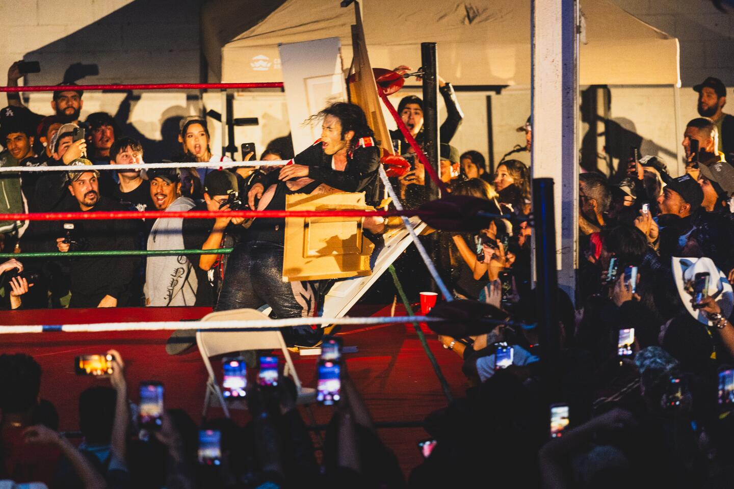 Santana Jackson is put through a door by another fighter at the Lucha Experience by MFN Lucha