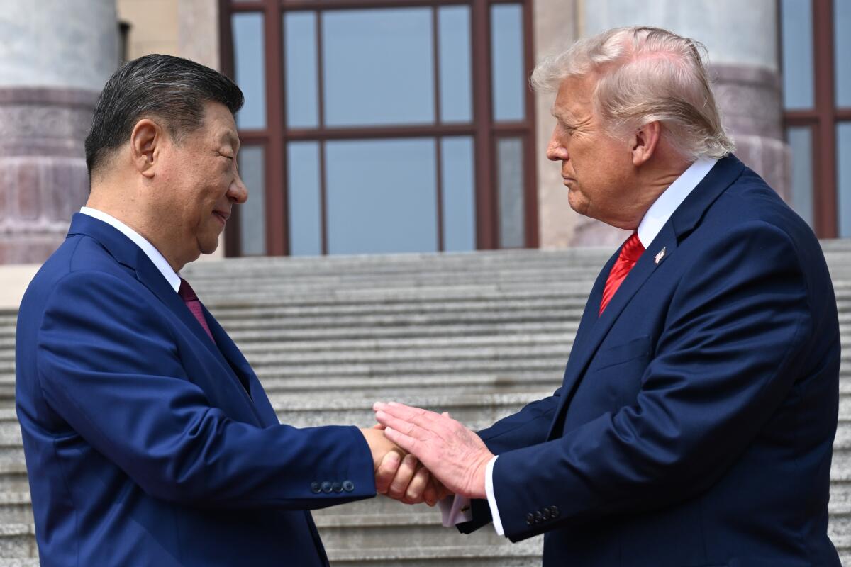 Chinese President Xi Jinping and President Trump shake hands at the Great Hall of the People.