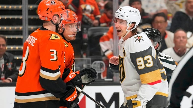 Vegas Golden Knights right wing Mitch Marner, right, laughs at...