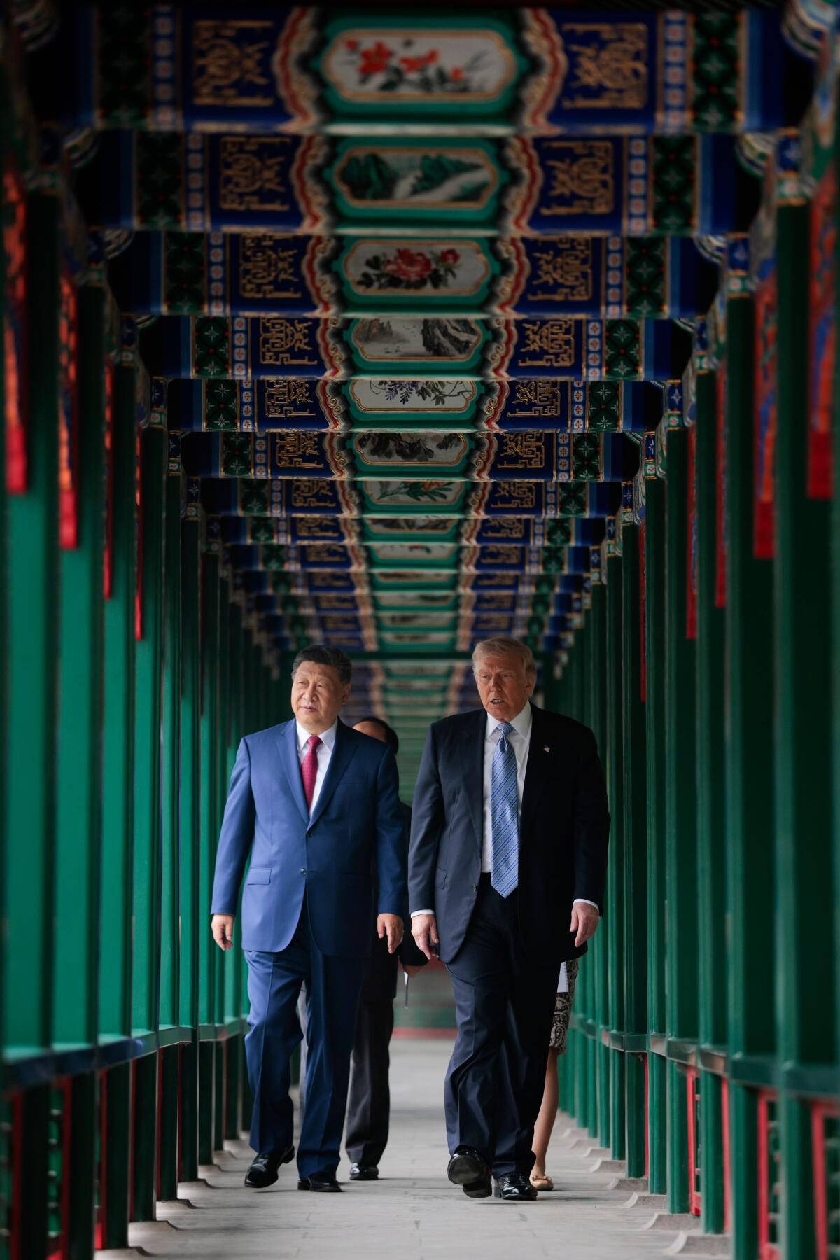 Chinese President Xi Jinping and President Trump participate in a friendship walk through Zhongnanhai Garden.