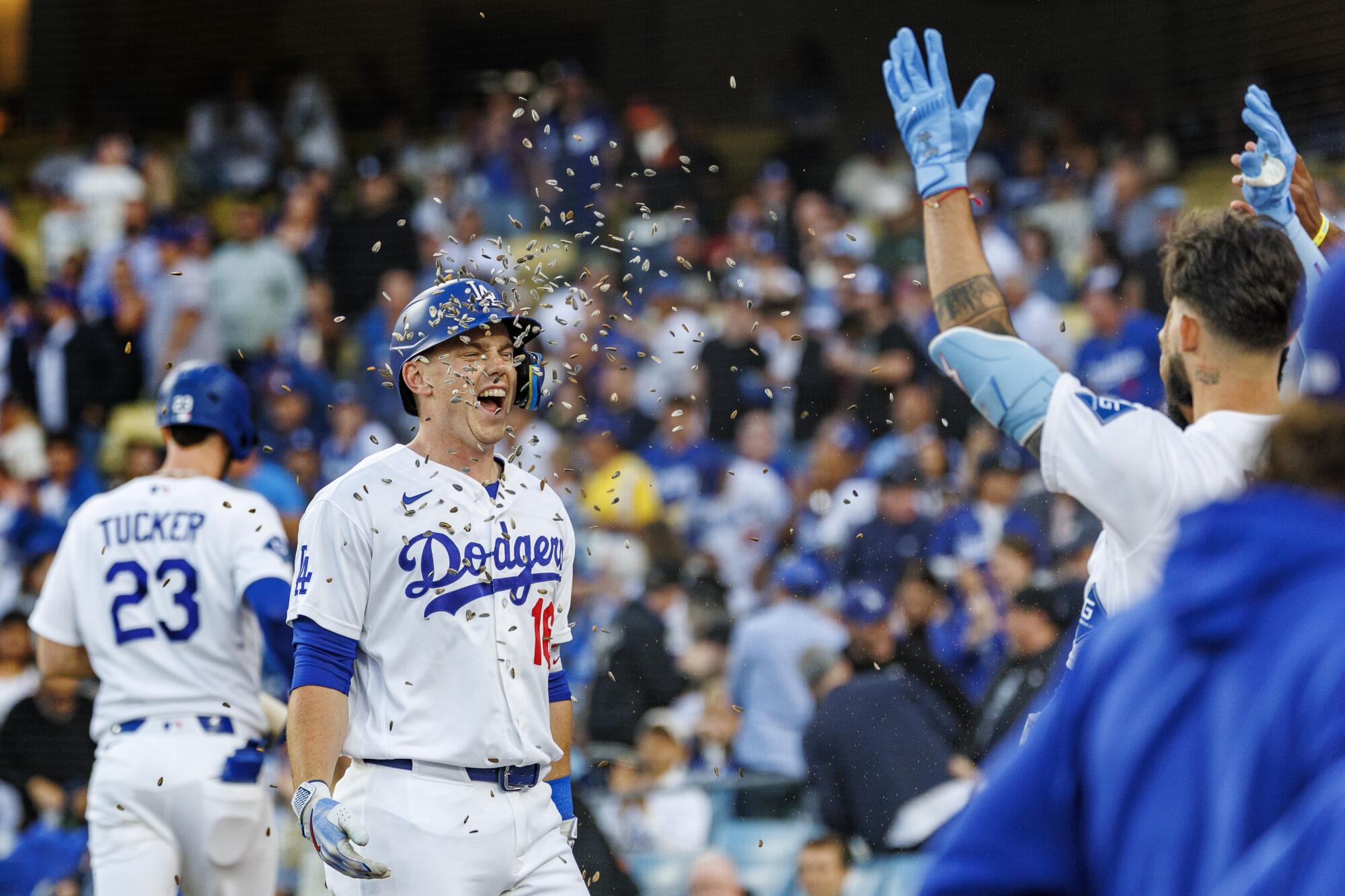 Will Smith gets a face full of sunflower seeds from teammate Andy Pages after hitting a leadoff home run.