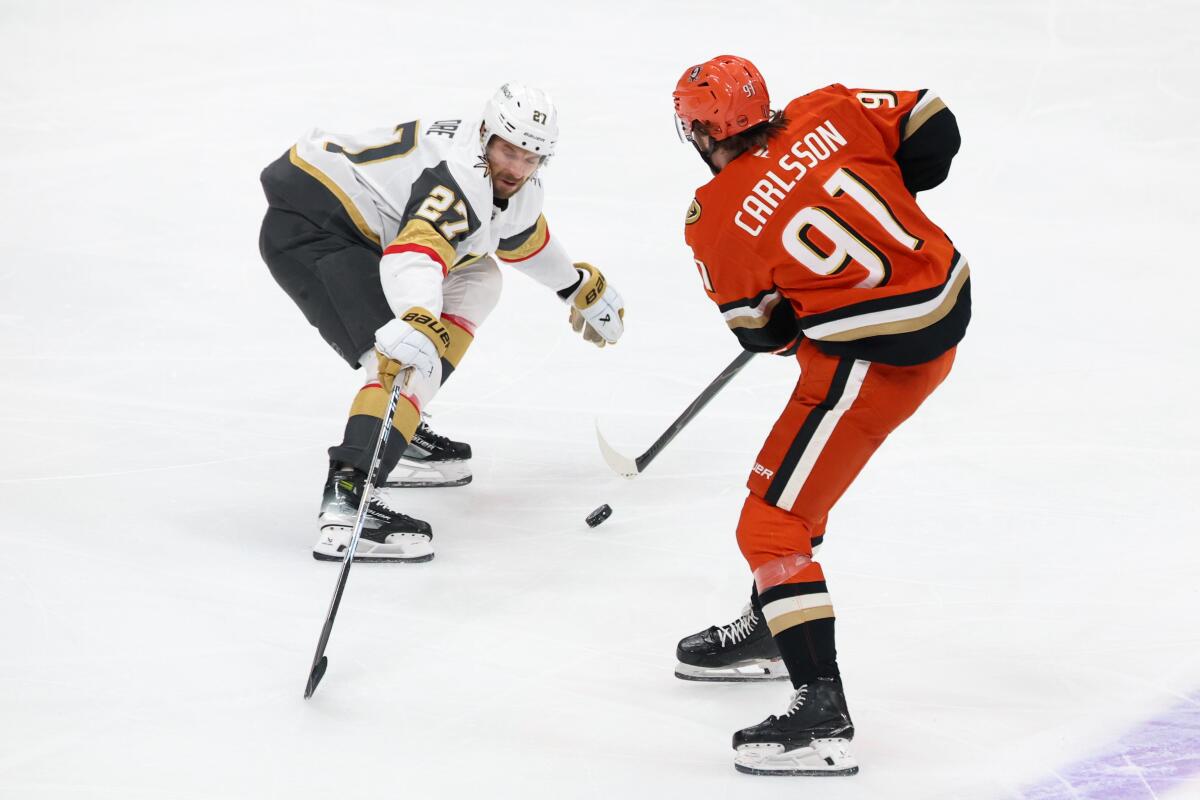 Ducks center Leo Carlsson passes the puck as Vegas' Shea Theodore defends during the second period.