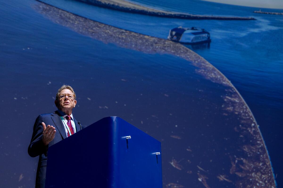 A man speaks during a media briefing about plans to install a trash interceptor in the San Gabriel River.