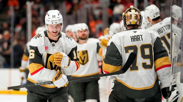 Vegas Golden Knights right wing Pavel Dorofeyev, left, celebrates his...