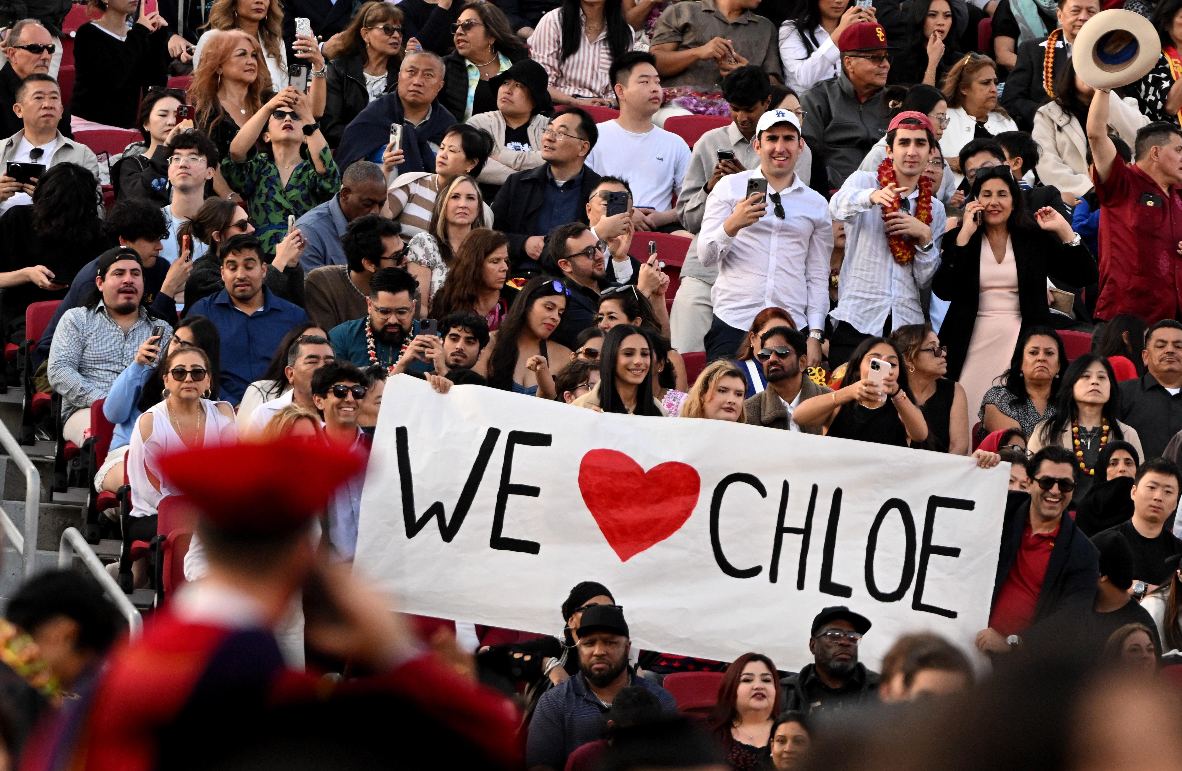 Family and friends cheer on their graduate during the USC’s...