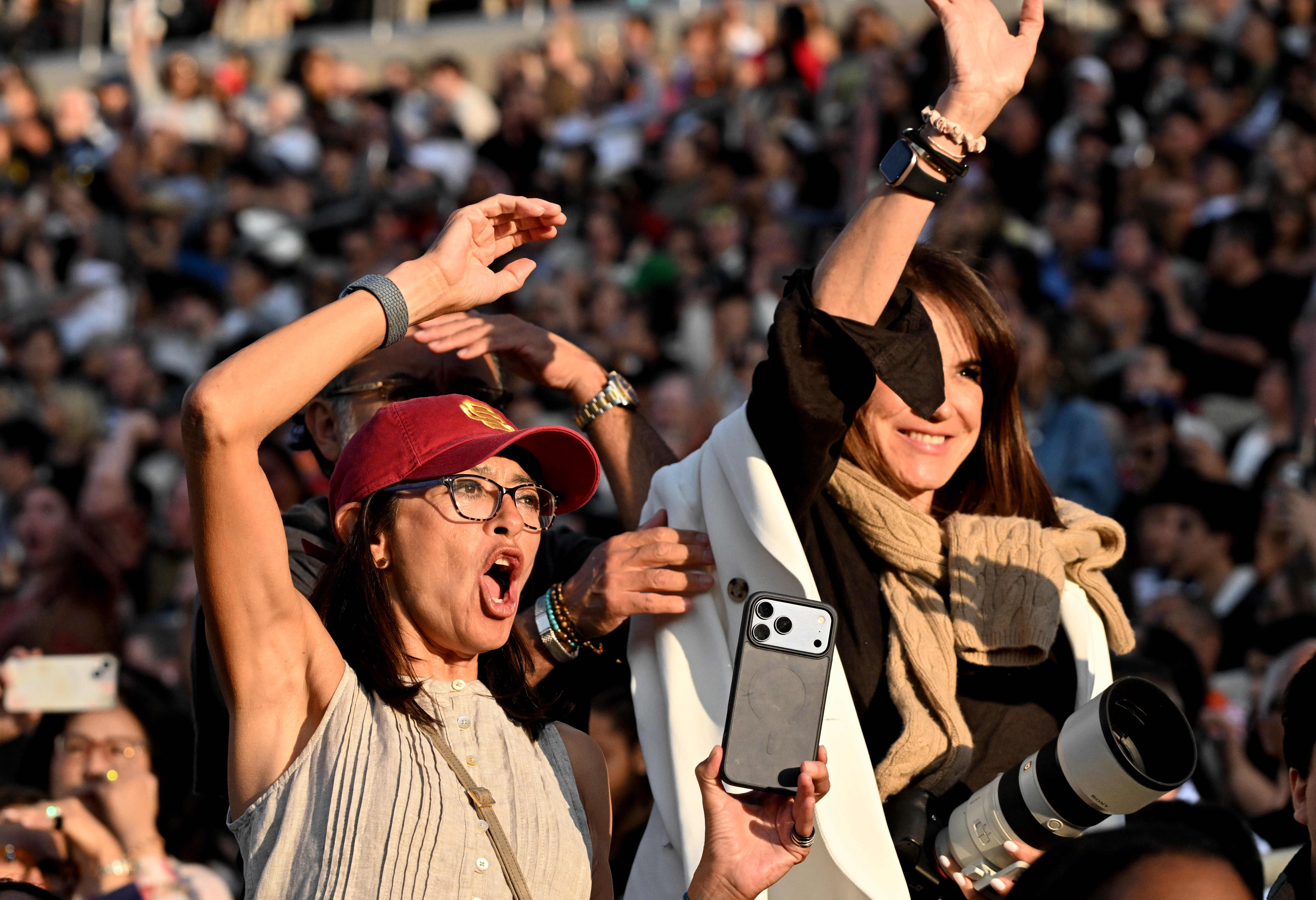 Family and friends cheer on their graduate during the USC’s...