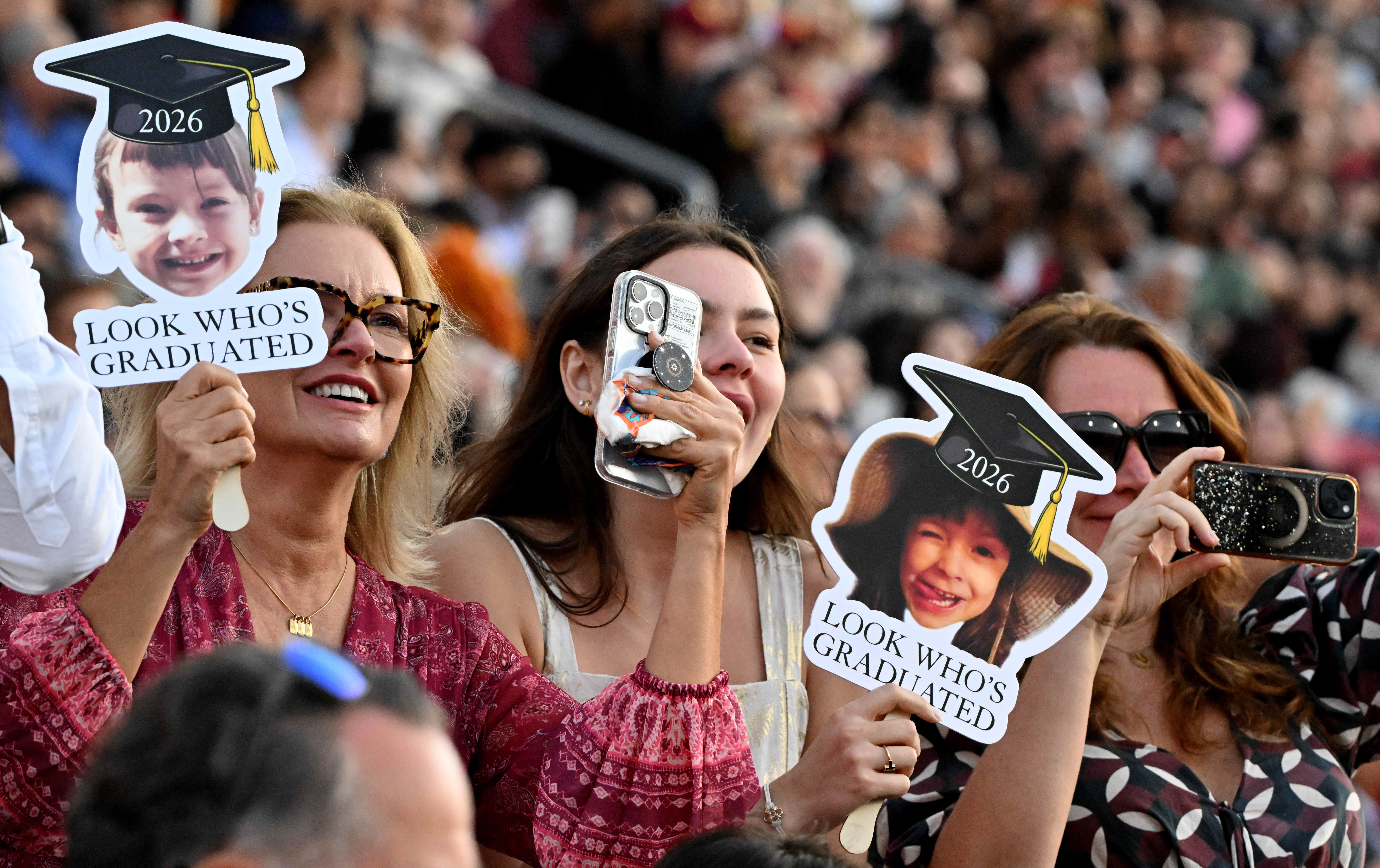Family and friends cheer on their graduate during the USC’s...