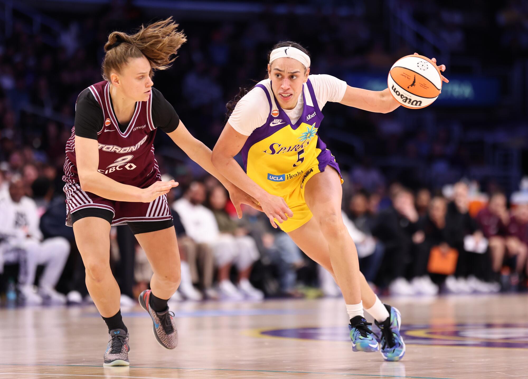 The Sparks' Dearica Hamby drives past the Tempo's Laura Juskaite Friday at Crypto.com Arena.