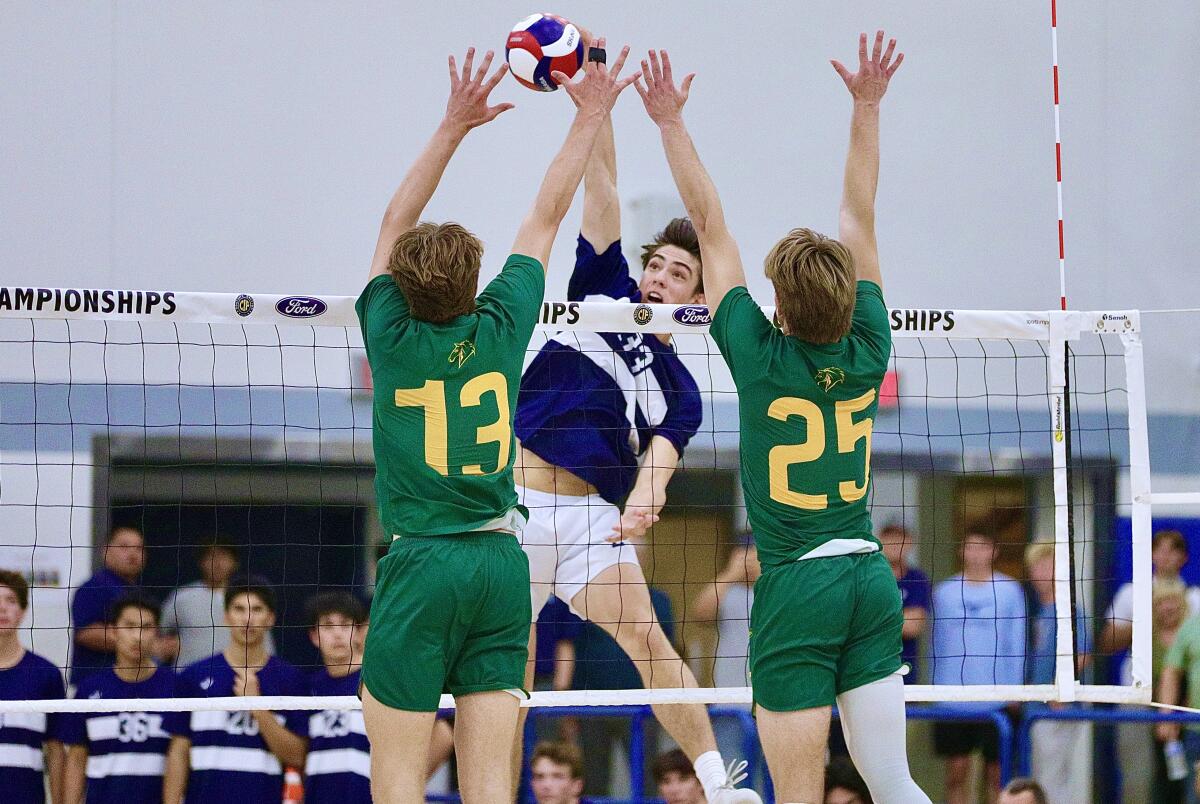 Loyola’s JP Wardy gets blocked by Mira Costa’s Miles Crotty and Colby Graham.