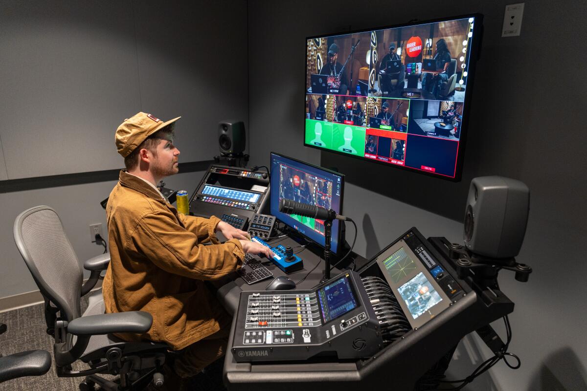 Chris Thomas, studio operator, works in the control room on the podcast, "Higher Learning."