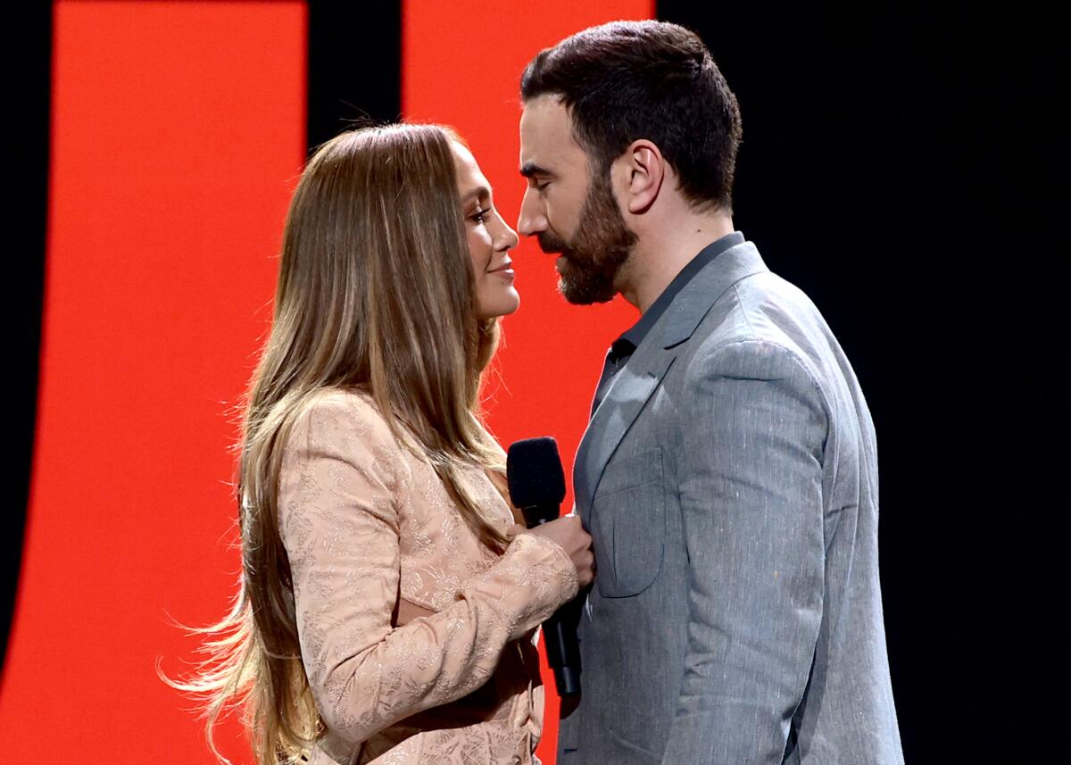 Jennifer Lopez and Brett Goldstein speak onstage during the 2026 Netflix Upfront at Sunset Pier 94 Studios on May 13.
