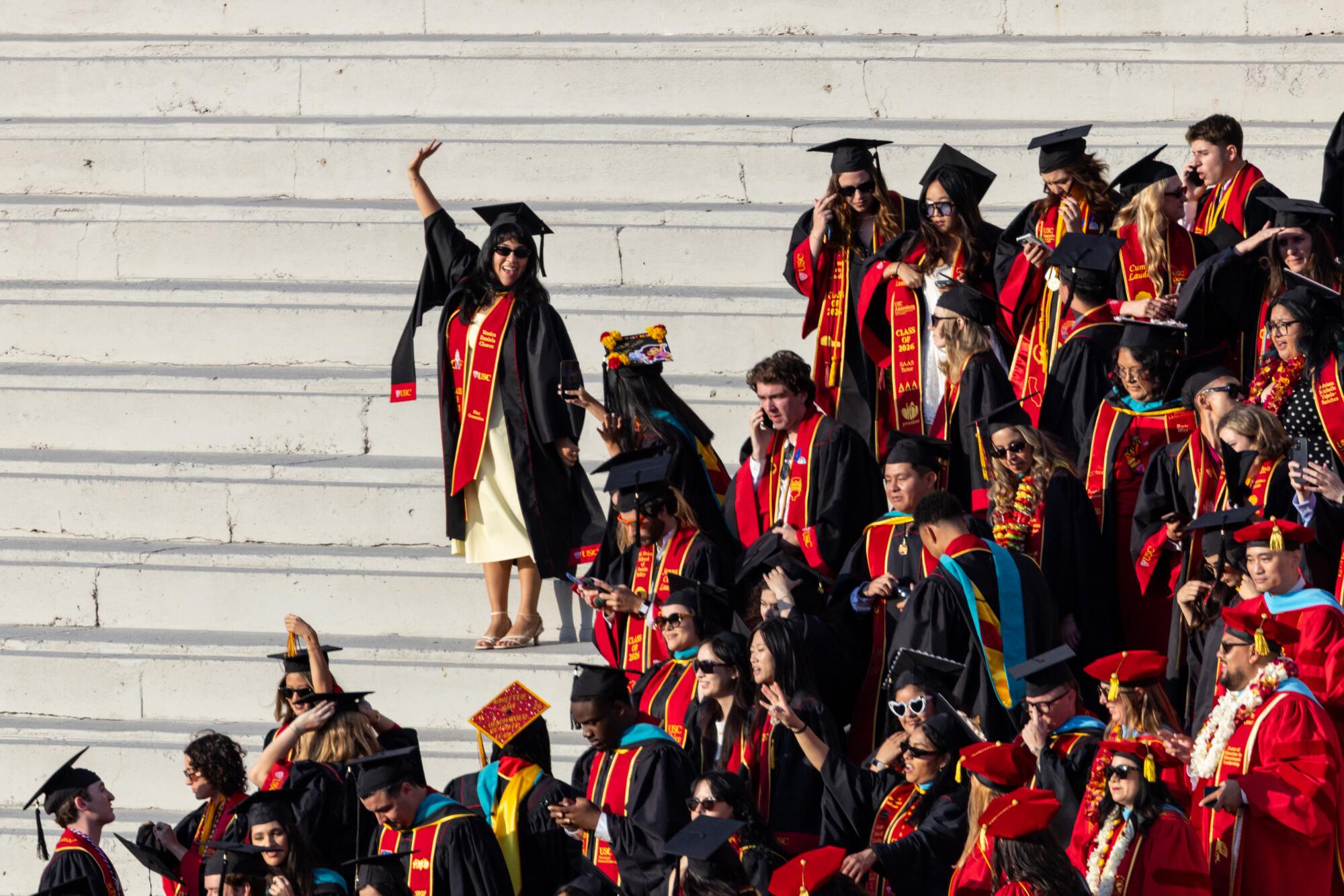 USC graduates walk down steps into the Coliseum for the commencement ceremony.