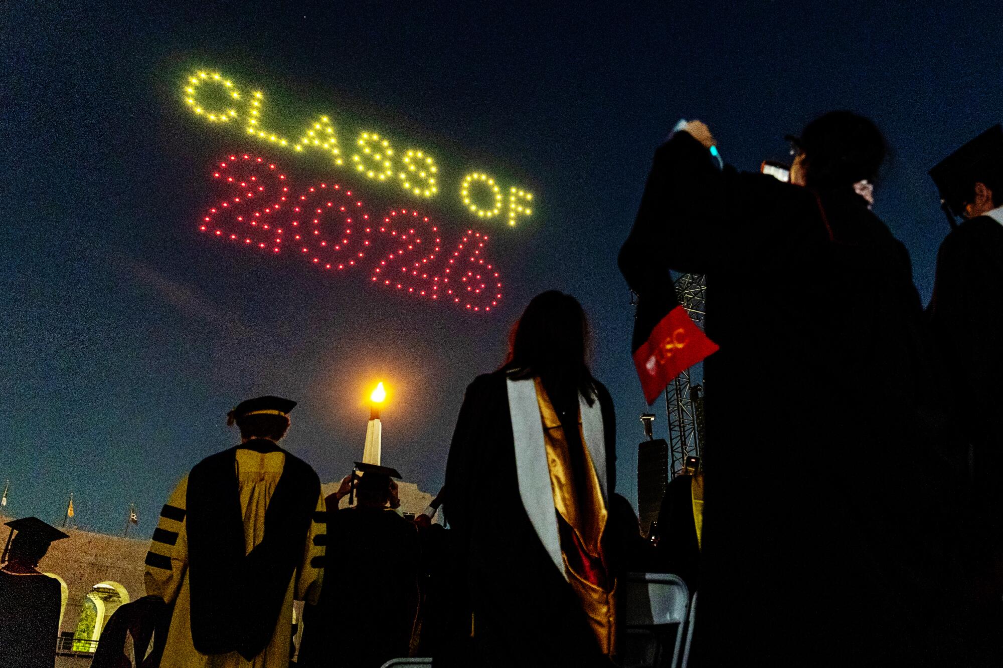 USC graduates watch the drone show at the end of the commencement ceremony.