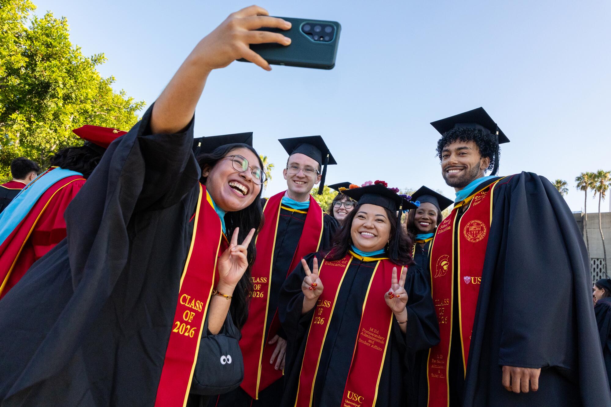 A group of graduates takes a selfie before the commencement ceremony.