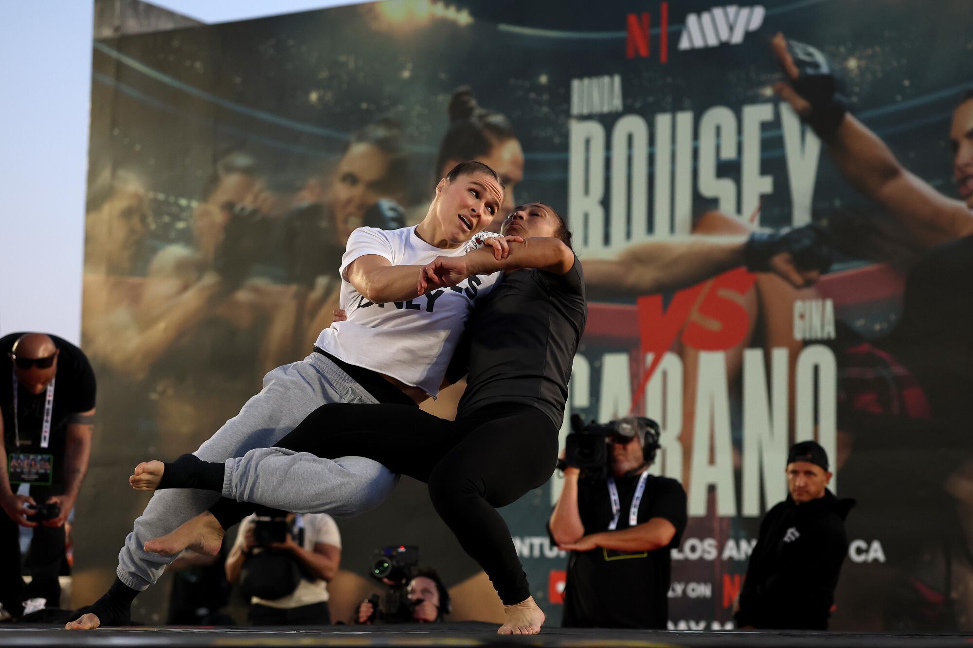 Ronda Rousey lunges forward and grapples with an opponent during an open workout at Venice Beach on Wednesday.