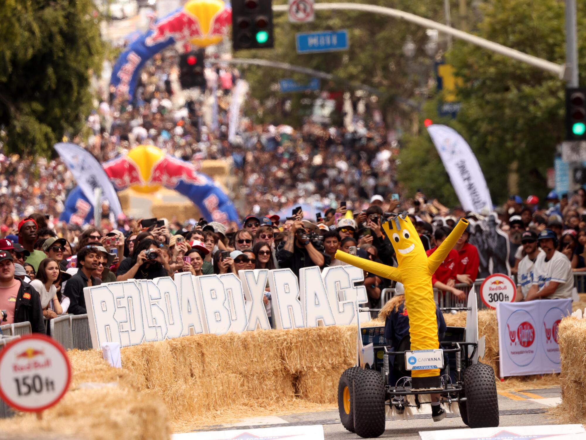 The Carvana cart races down 1st Street as hundreds of spectators attended the Red Bull Soapbox Race.