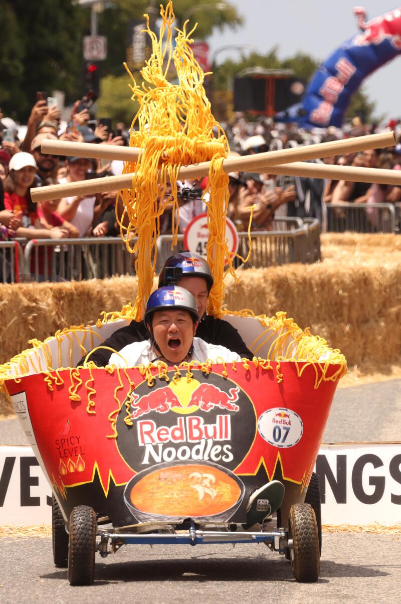 The Chicks and Ra-Men cart flies down 1st Street.