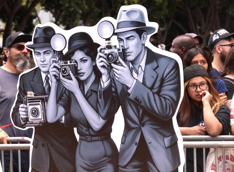 Cardboard cutouts of photographers are station along the route.