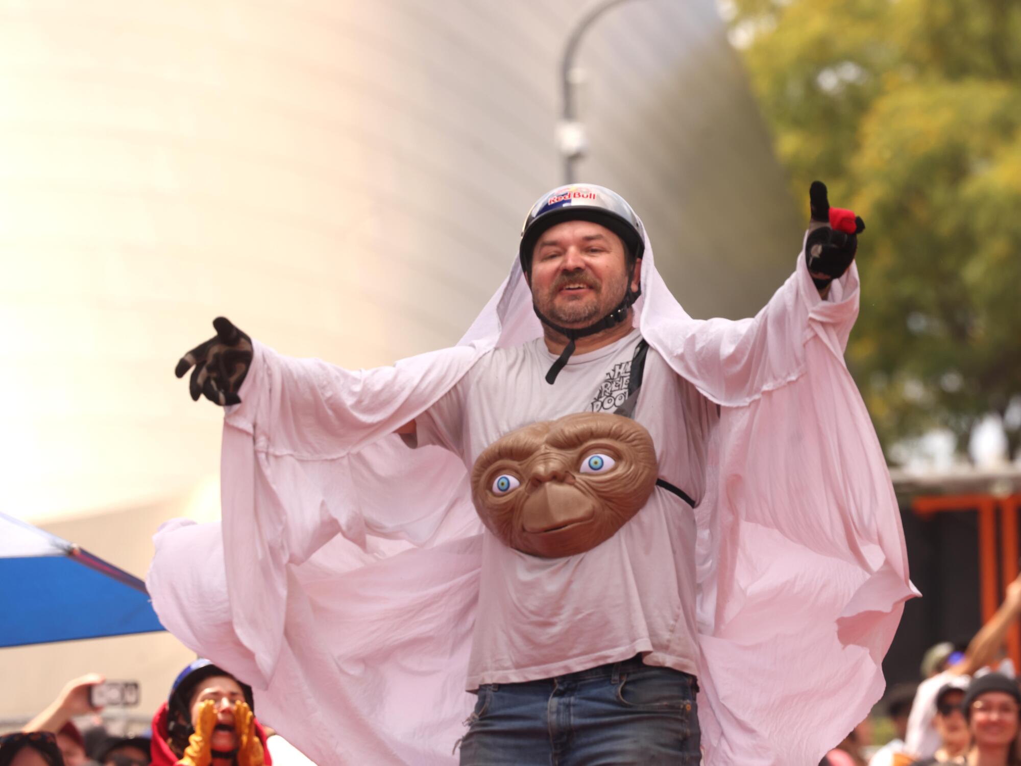 A member of the E.T. themed cart performs before the teams decent down 1st Street.