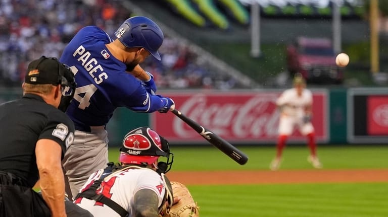 Los Angeles Dodgers' Andy Pages, center, hits a three-run home...