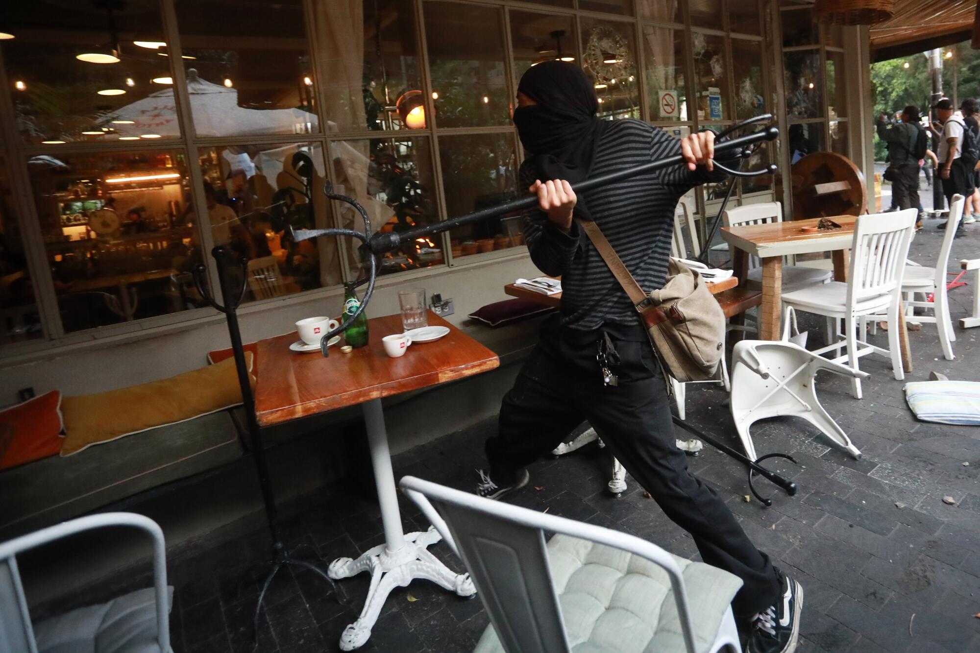 Demonstrator throws objects at a restaurant